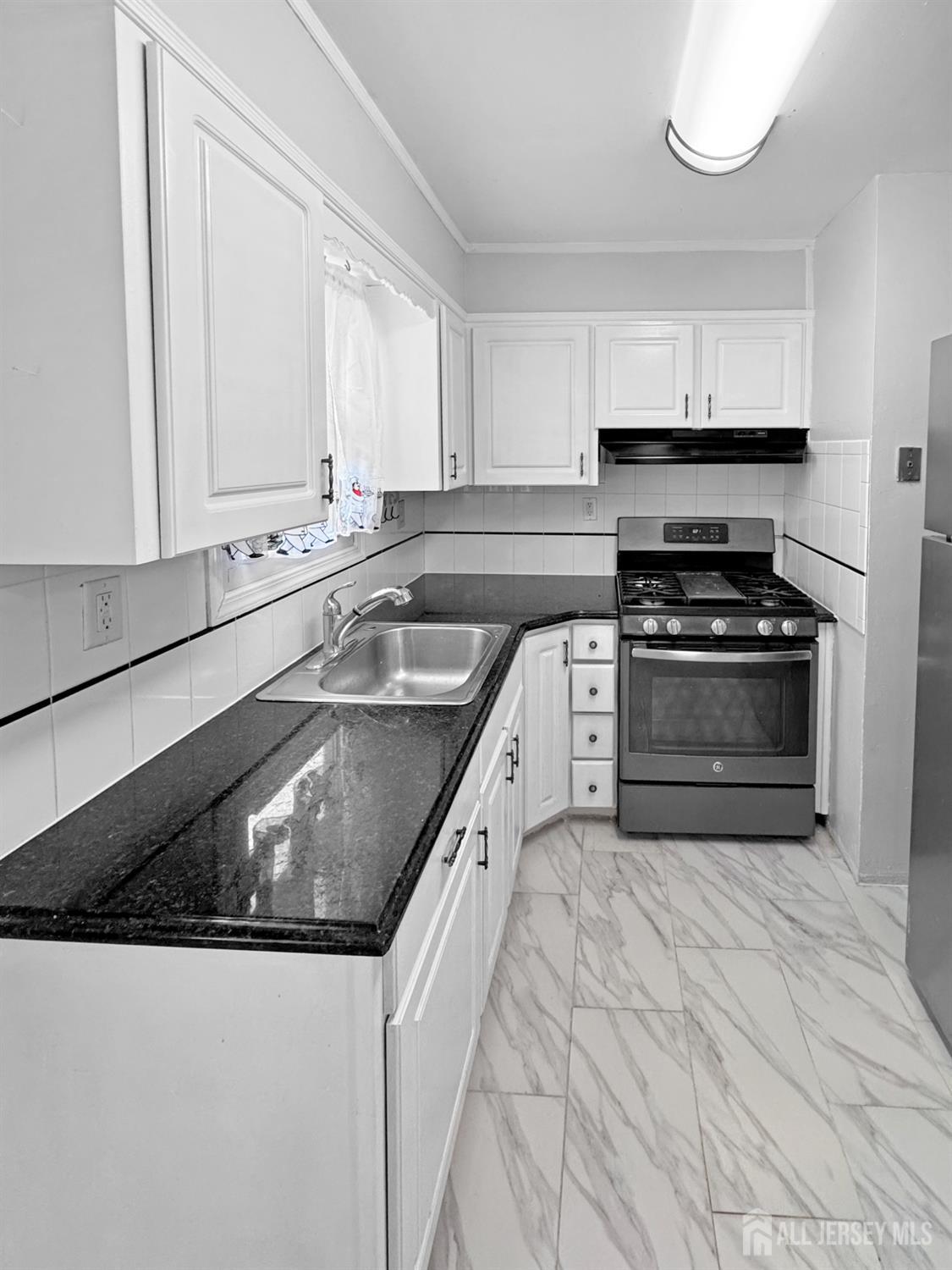 117 Old Post Road Edison, NJ 08817 - Photo 7 of 22 a kitchen with granite countertop a sink stainless steel appliances and cabinets