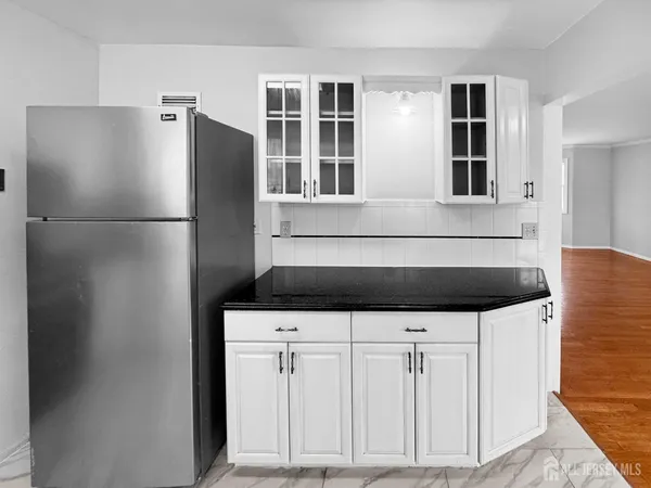 a kitchen with stainless steel appliances a refrigerator and cabinets