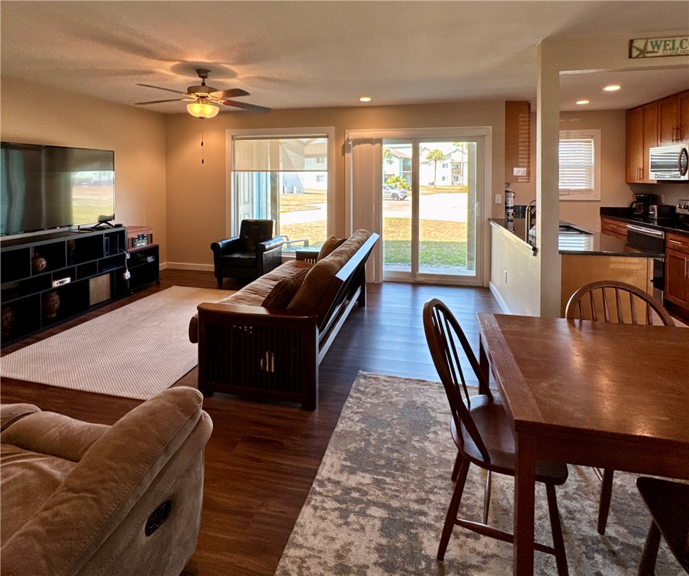 230 Cut-Off Road, Unit B107 Port Aransas, TX 78373 - Photo 2 of 25 a living room with furniture a flat screen tv and a large window