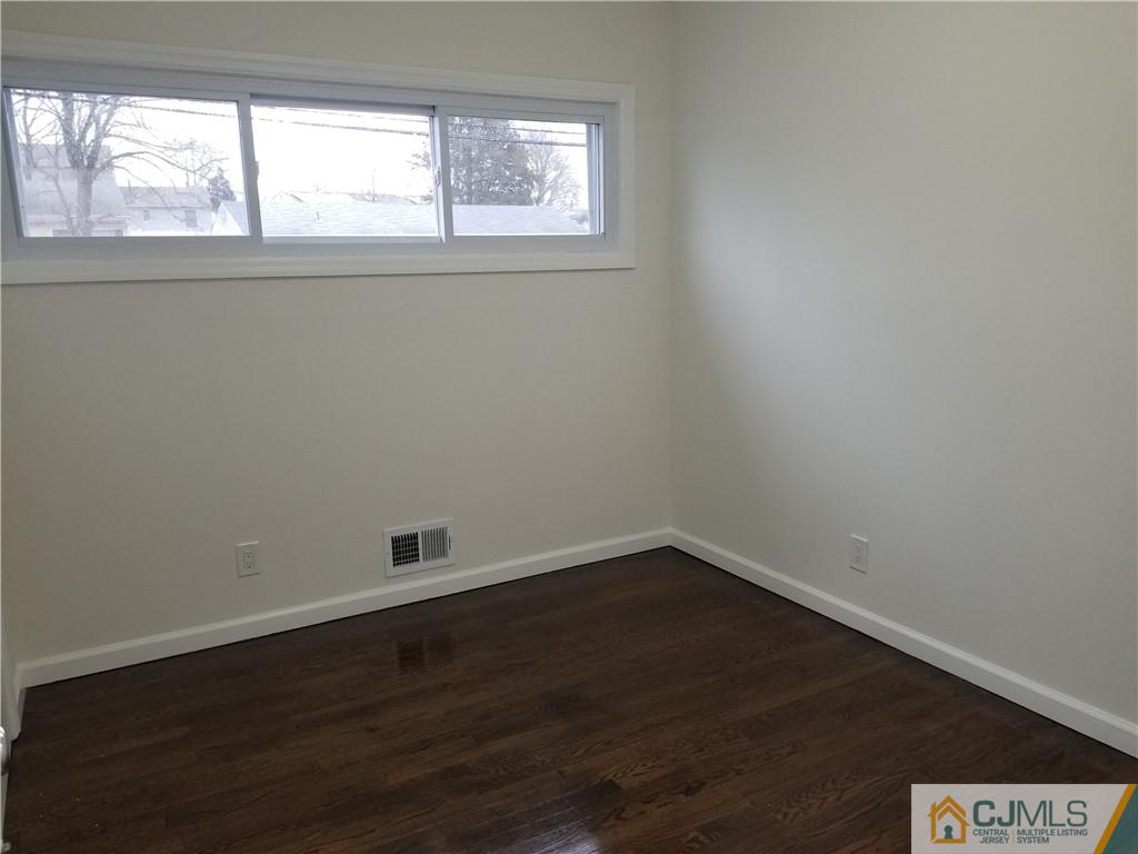 9 Yale Road Old Bridge, NJ 08859 - Photo 14 of 20 an empty room with wooden floor and windows