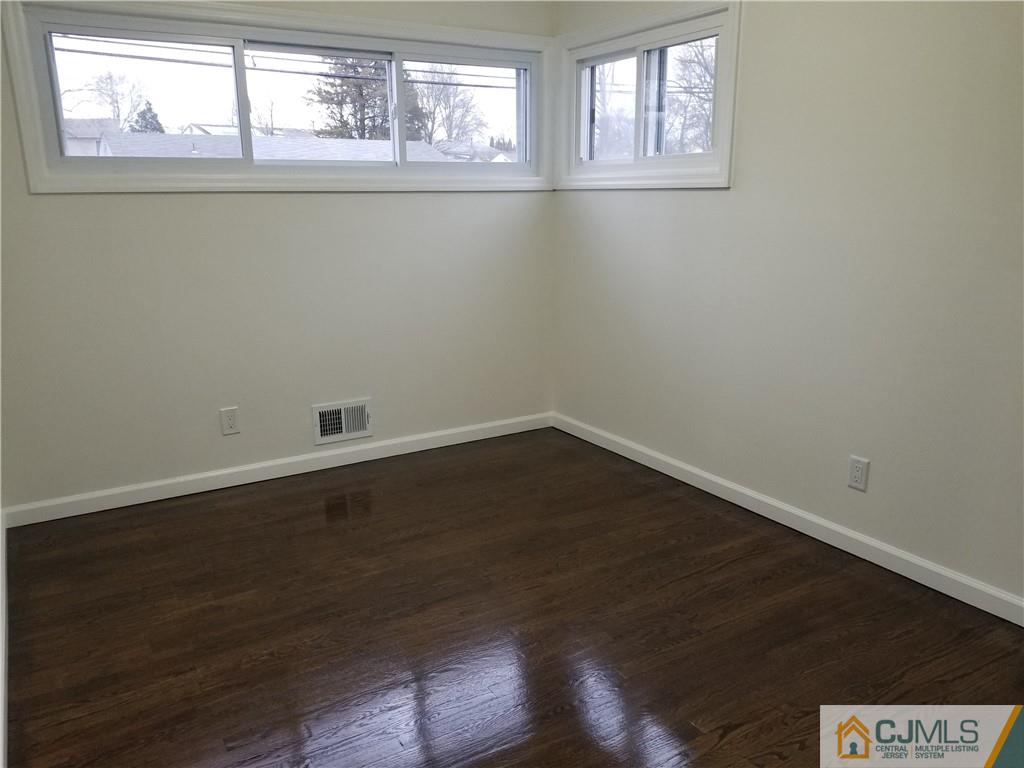 9 Yale Road Old Bridge, NJ 08859 - Photo 15 of 20 an empty room with wooden floor and windows