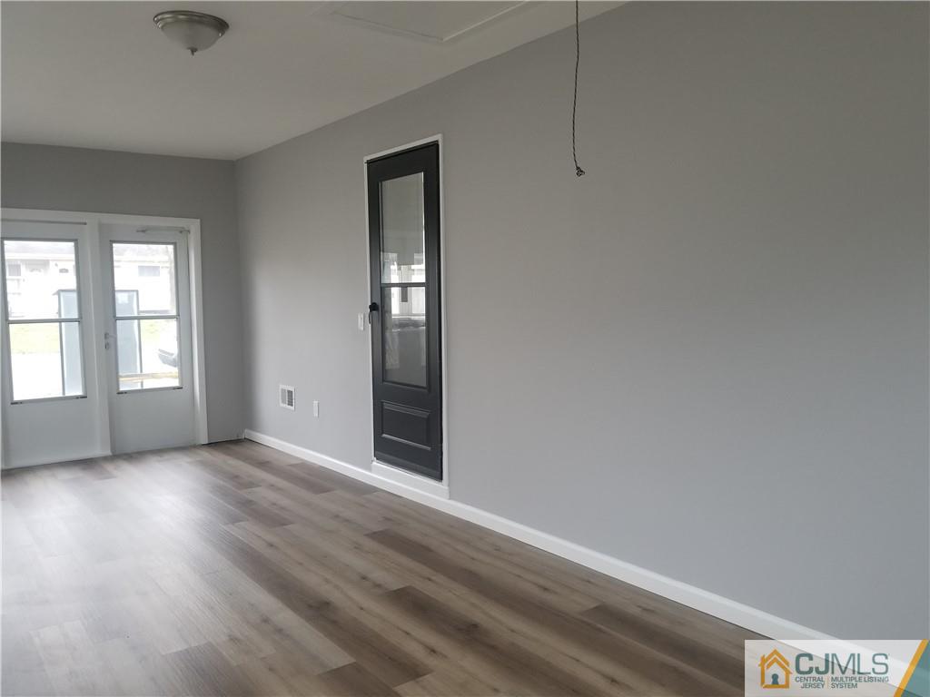 9 Yale Road Old Bridge, NJ 08859 - Photo 20 of 20 an empty room with wooden floor and windows