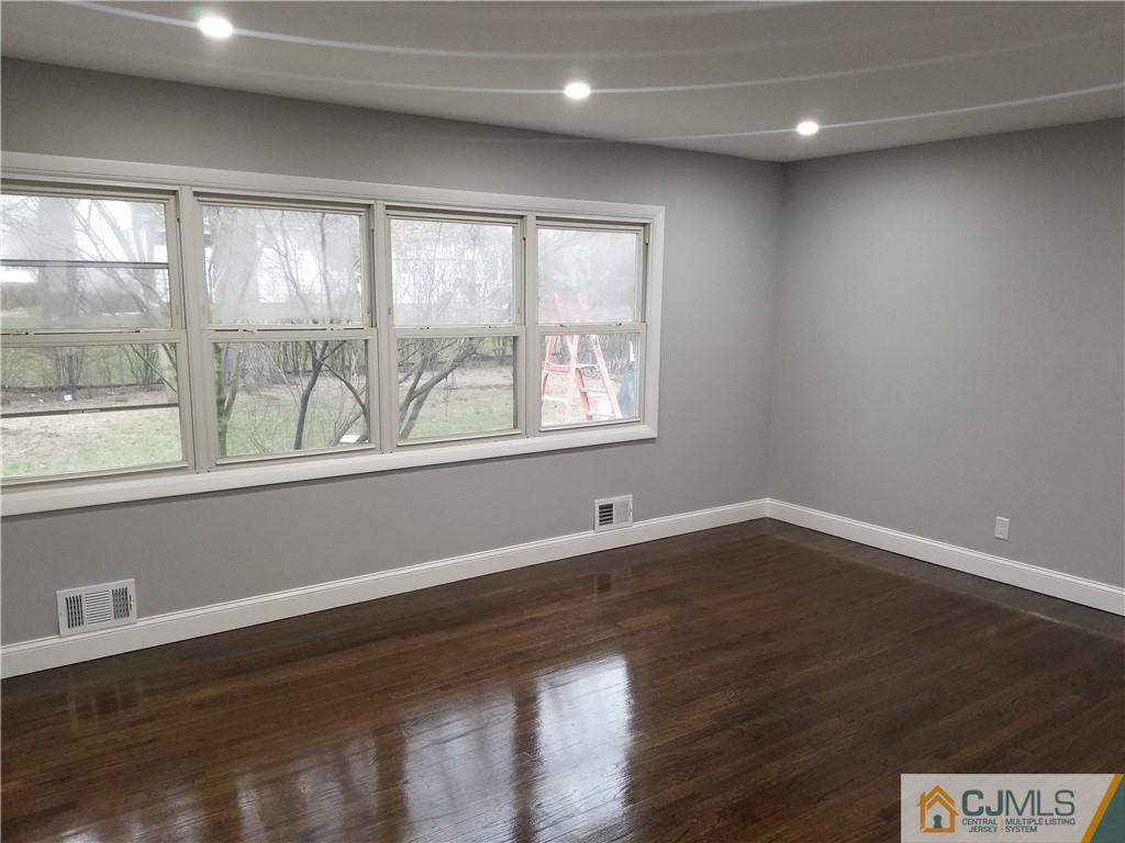 9 Yale Road Old Bridge, NJ 08859 - Photo 10 of 20 a view of an empty room with wooden floor and a window