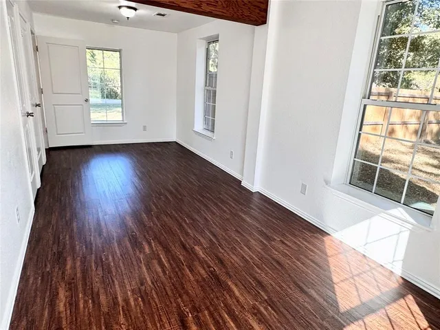 a bathroom with a granite countertop toilet sink and mirror