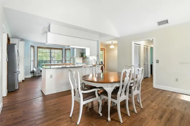 a dining room with furniture and wooden floor