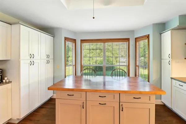 a kitchen with a window and cabinets
