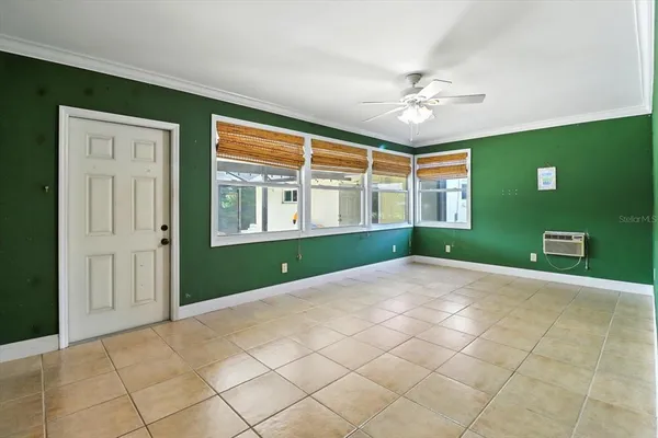 a view of a livingroom with a ceiling fan and window