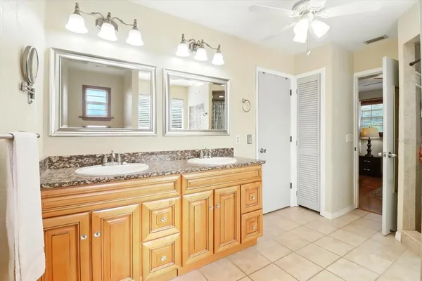a bathroom with a sink vanity and mirror