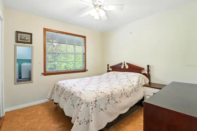 a bedroom with a bed and window