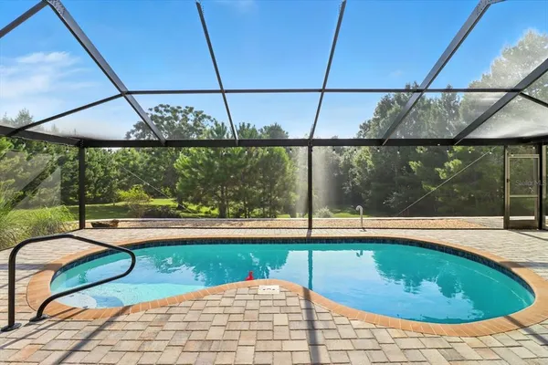 a swimming pool with outdoor seating