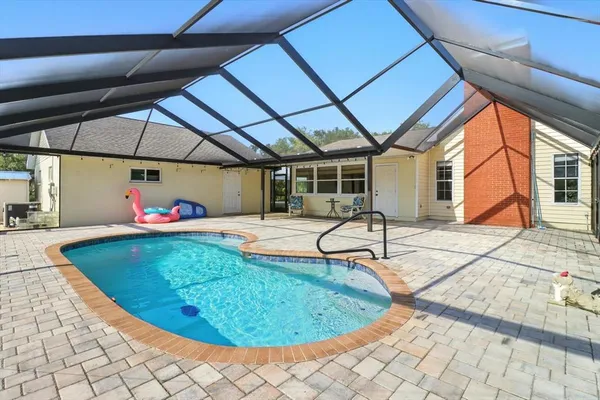a swimming pool with outdoor seating