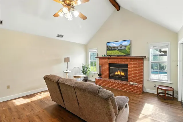 a living room with furniture a window and a fireplace