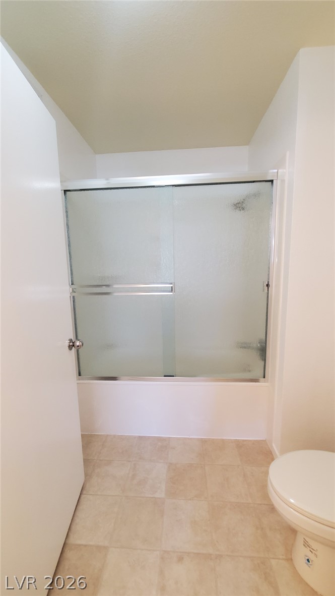 8070 West Russell Road, Unit 2105 Las Vegas, NV 89113 - Photo 7 of 10 A well-maintained bathroom with a sleek shower-over-tub combination and durable tile flooring.