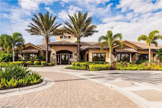 a front view of multiple houses with yard