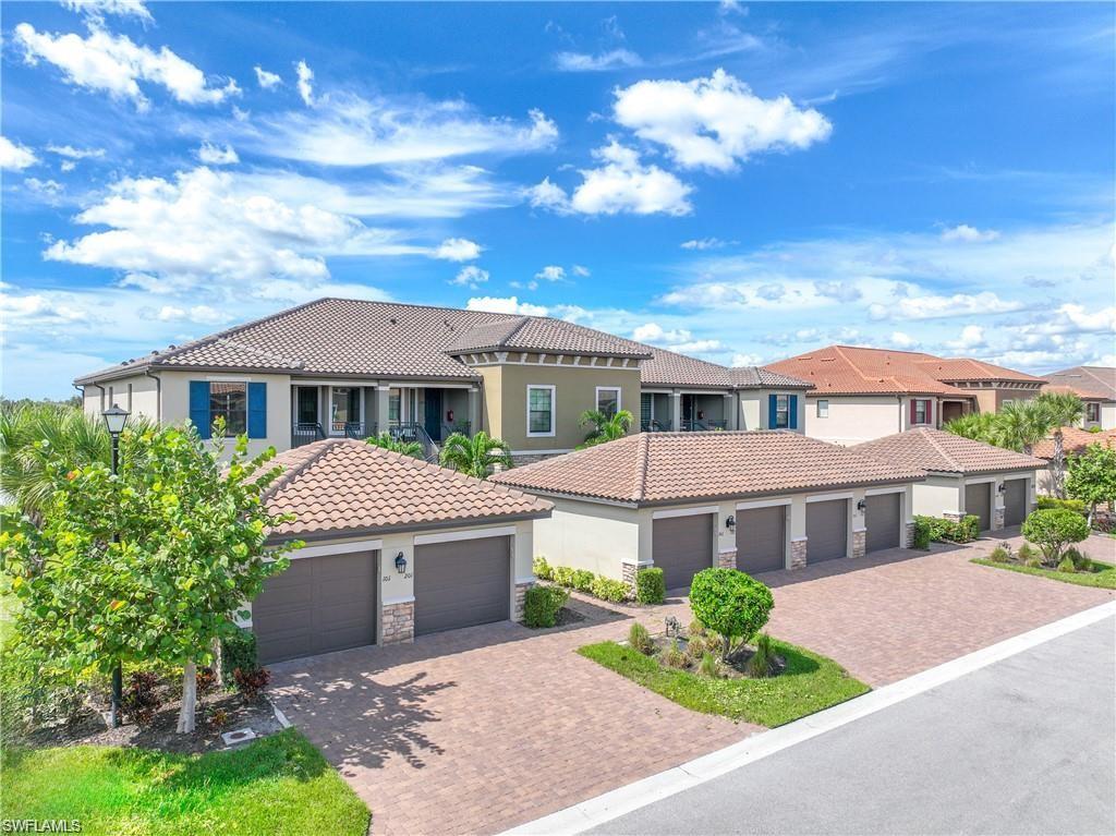 9377 Pocida Court, Unit 202 Naples, FL 34119 - Photo 2 of 30 a front view of a house with garden
