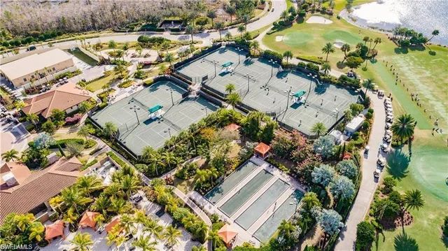 a view of a house with big yard and potted plants