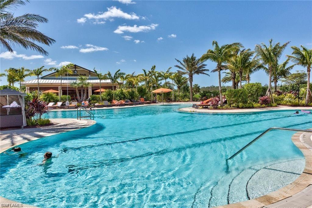 9377 Pocida Court, Unit 202 Naples, FL 34119 - Photo 27 of 30 a view of a house with big yard and potted plants