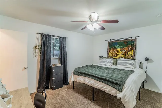 a bedroom with a bed and ceiling fan