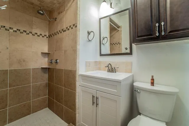 a bathroom with a sink toilet and shower