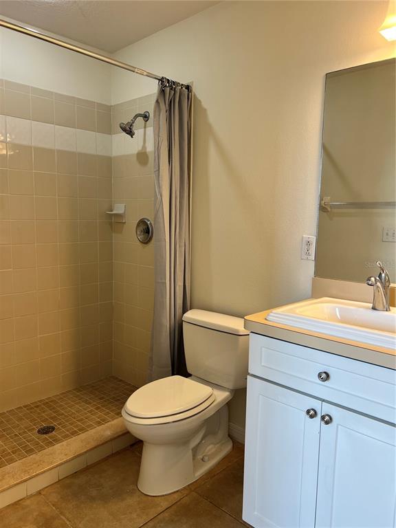 8370 Wingate Drive, Unit 718 Sarasota, FL 34238 - Photo 14 of 49 a bathroom with a sink a toilet and shower