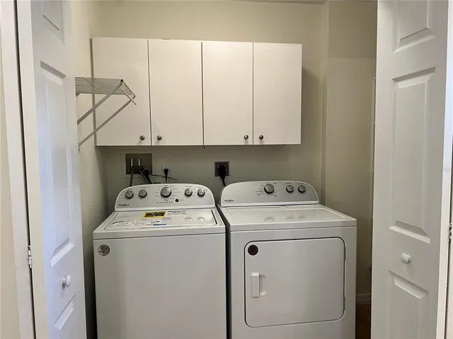 a view of storage and utility room with washer and dryer