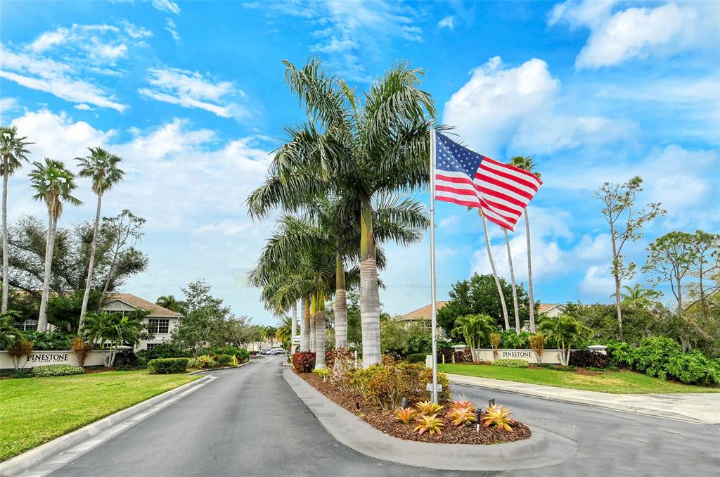 8370 Wingate Drive, Unit 718 Sarasota, FL 34238 - Photo 23 of 49 a front view of a house with a yard and outdoor seating