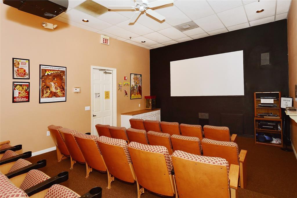 8370 Wingate Drive, Unit 718 Sarasota, FL 34238 - Photo 30 of 49 a projector room with furniture and a flat screen tv