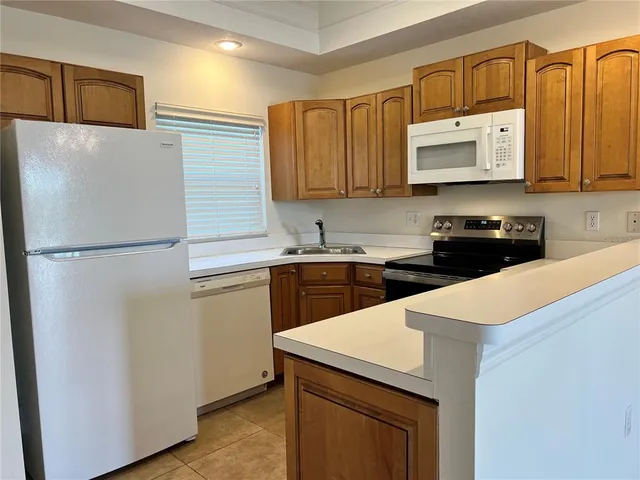 a kitchen with a sink a stove and refrigerator