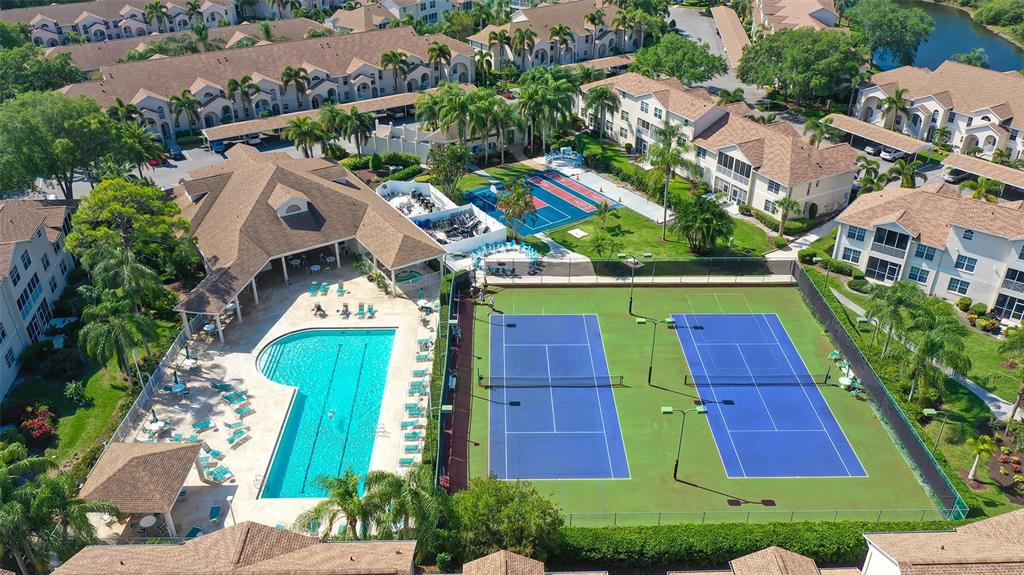 8370 Wingate Drive, Unit 718 Sarasota, FL 34238 - Photo 40 of 49 an aerial view of a house with a yard and swimming pool