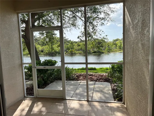 a view of a floor to ceiling window next to a yard