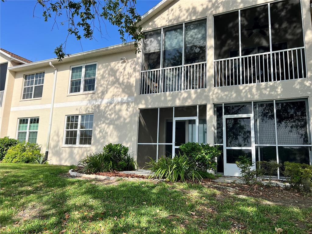 8370 Wingate Drive, Unit 718 Sarasota, FL 34238 - Photo 9 of 49 front view of a house with a yard