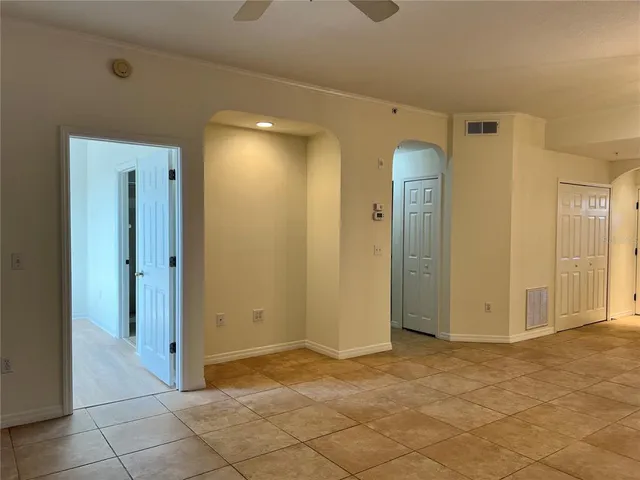 an empty room with closet and a bathroom