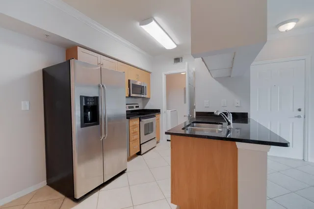 a kitchen with stainless steel appliances granite countertop a stove and a microwave