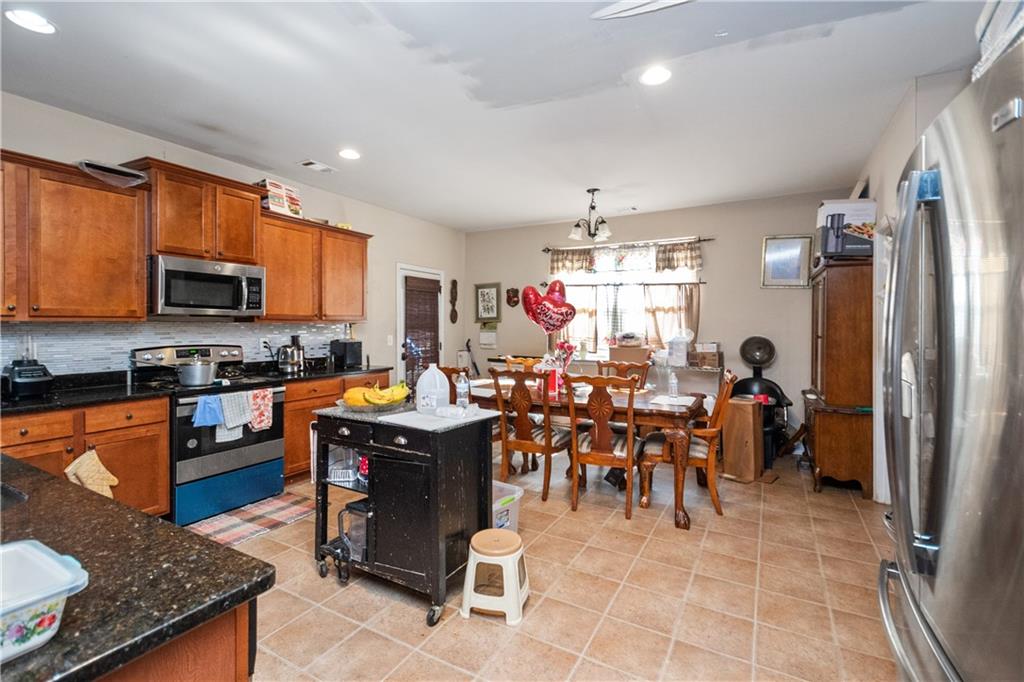 12148 Flannery Lane Hampton, GA 30228 - Photo 2 of 8 a group of people sitting in a kitchen