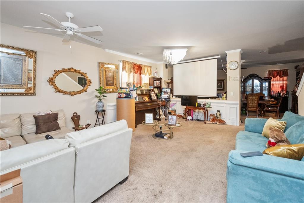 12148 Flannery Lane Hampton, GA 30228 - Photo 3 of 8 a living room with furniture and white walls
