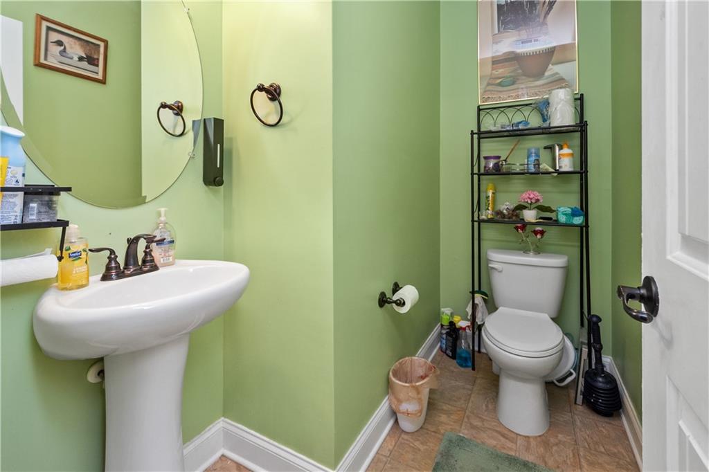 12148 Flannery Lane Hampton, GA 30228 - Photo 4 of 8 a bathroom with a toilet sink and mirror
