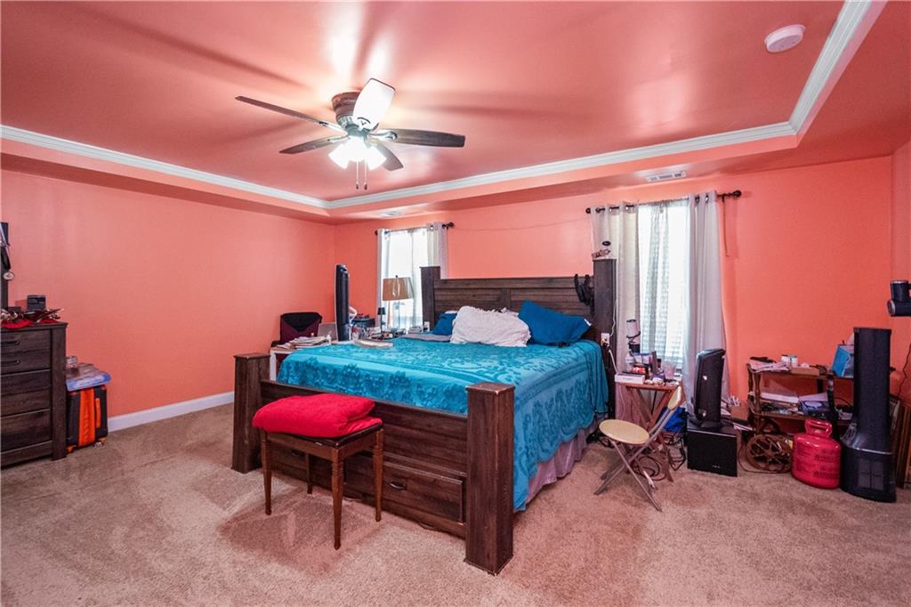 12148 Flannery Lane Hampton, GA 30228 - Photo 5 of 8 a bedroom with a bed a desk and chair