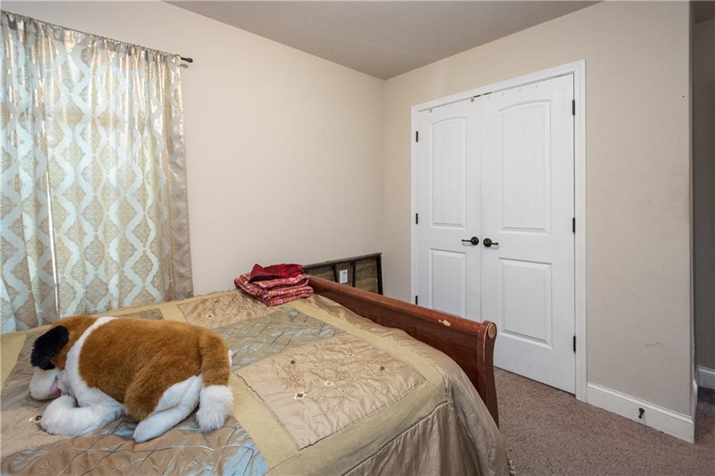 12148 Flannery Lane Hampton, GA 30228 - Photo 8 of 8 a bedroom with a bed and a window