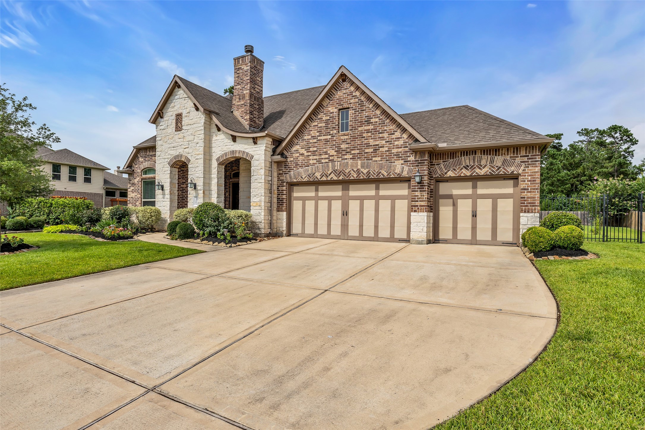 14003 South Evergreen Ridge Court Conroe, TX 77384 - Photo 2 of 43 Four-car garage and extra-wide driveway provide exceptional parking, storage, and workspace.