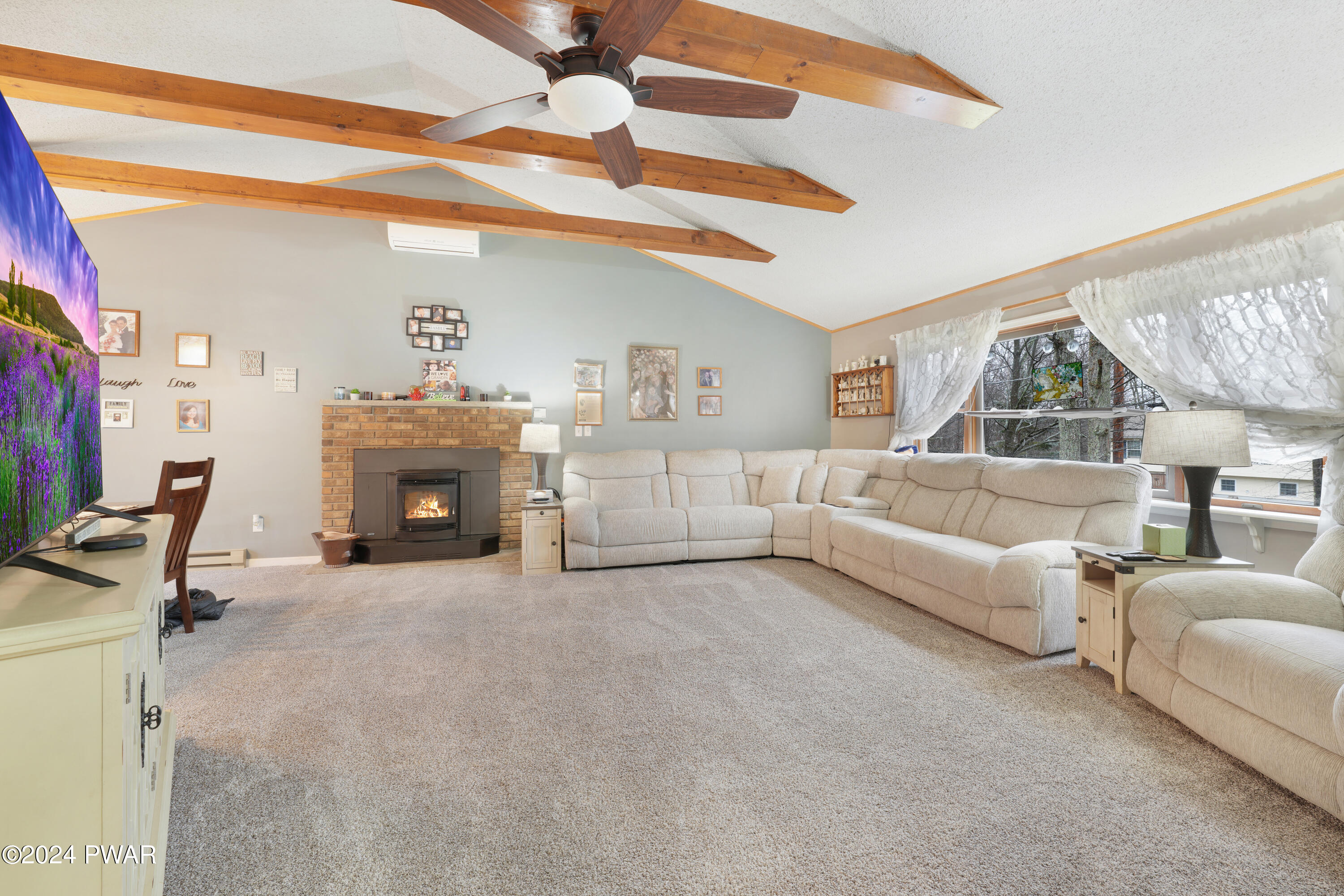 161 Skyview Road Dingmans Ferry, PA 18328 - Photo 5 of 31 a living room with furniture and a fireplace
