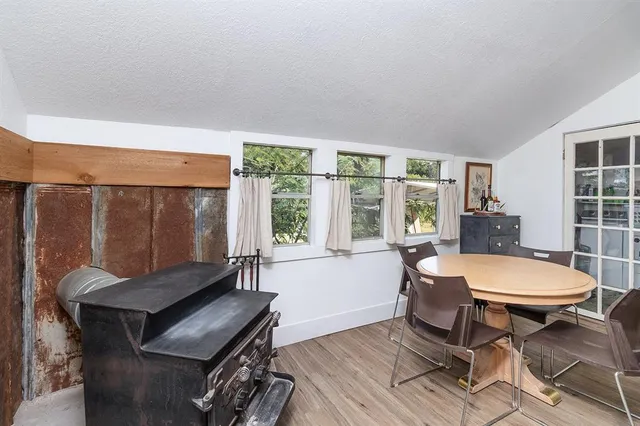 a living room with a table chairs and a large window