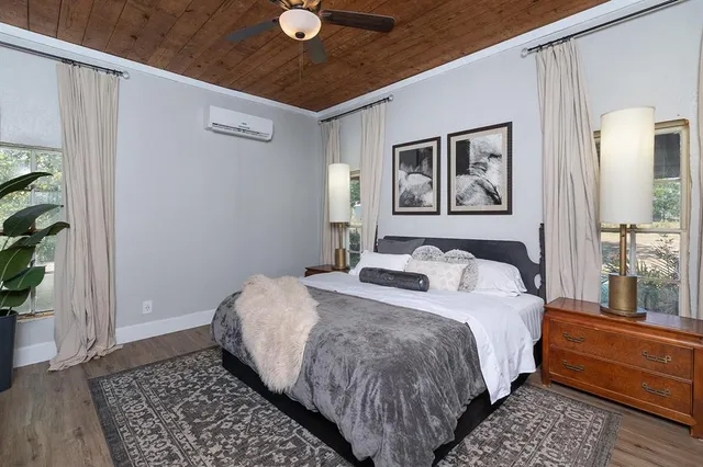 a bedroom with a bed and a window with potted plant