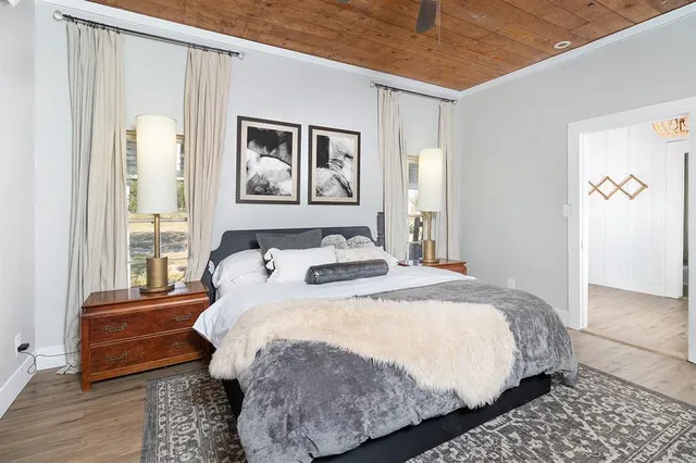 a bedroom with a bed and a painting on the wall