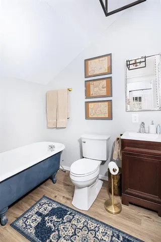 a bathroom with a sink toilet and a window