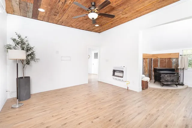 a view of a livingroom with wooden floor and a ceiling fan