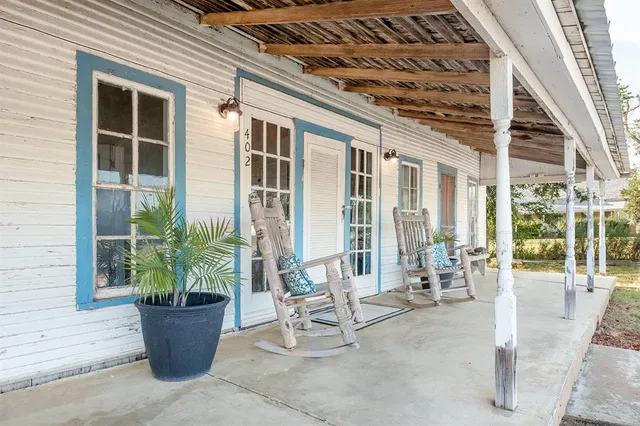 a view of a patio with couple of potted plants