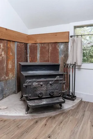 a living room with furniture a fireplace and a floor to ceiling window