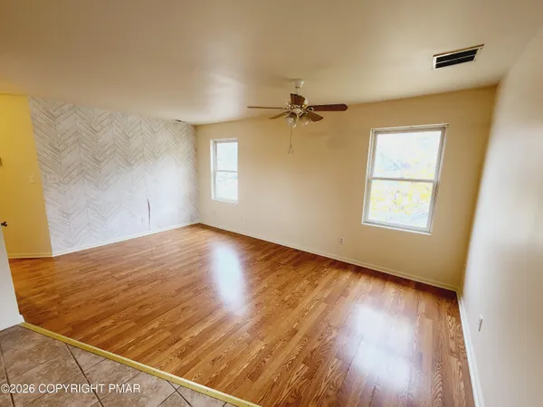 a view of a kitchen with a sink and a refrigerator