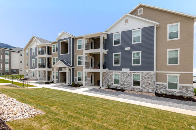 4655 South 720 West, Unit I303 Mapleton, UT 84664 - Photo 1 of 15 Modern multi-story building featuring varied siding materials, including horizontal panels, stucco, and stacked stone accents