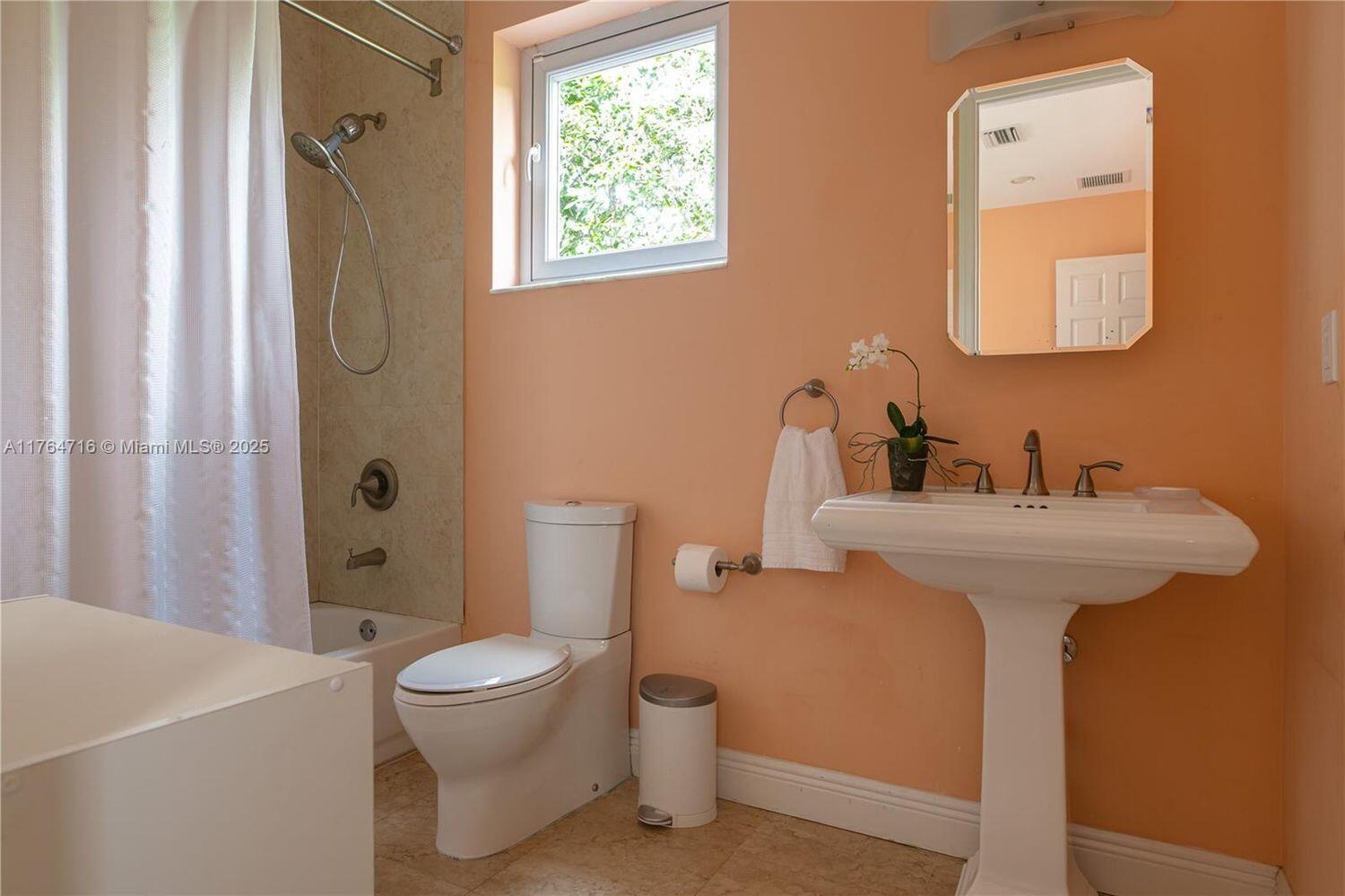 12301 Southwest 107th Avenue Miami, FL 33176 - Photo 37 of 58 a bathroom with a toilet sink and mirror